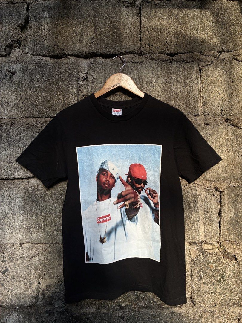 Supreme Photo Tee Black Size S (Category: Tshirts & Polo Shirts ) located in Manila. Submitted by assortedgoodsv3 (Listing ID 1468712969, Image 1). Description: - Brand: Supreme - Item: Photo Tee - Color: Black - Size: Small (S) - Material: 100% Cotton, Made in U.S.A. (Pre-shrunk) - Design: Classic graphic print on front with two guys in box logos; small paisley print near bottom back hem - Details: Standard crew neck, clean tags attached inside 