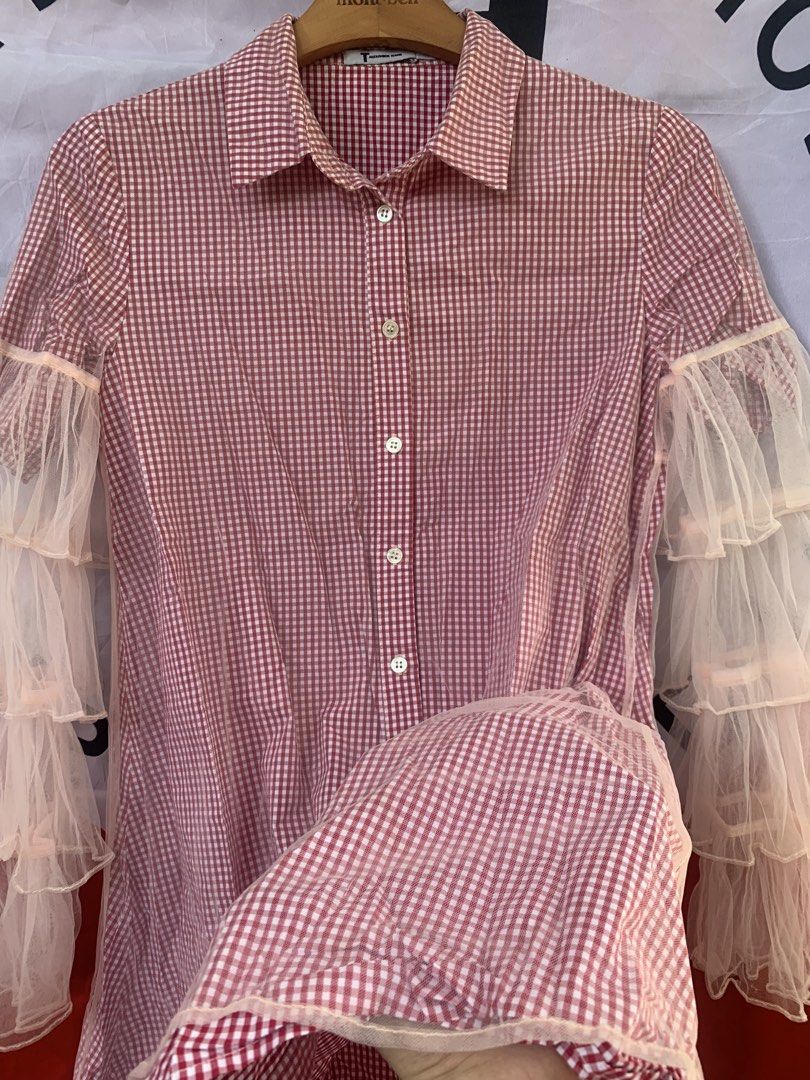 T by Alexander Wang Red/Pink Gingham Tulle Ruffle Polo Button Down (Category: Blouses) located in Angeles City. Submitted by kj772c_ (Listing ID 1468741419, Image 3). Description: - Brand: T by Alexander Wang - Size: S (tag attached) - Color/Pattern: Red and white gingham - Material: Lightweight fabric with sheer tulle ruffles - Features: Collared neck, front button closure, layered tulle ruffle long sleeves - Style: Unique statement piece blendi