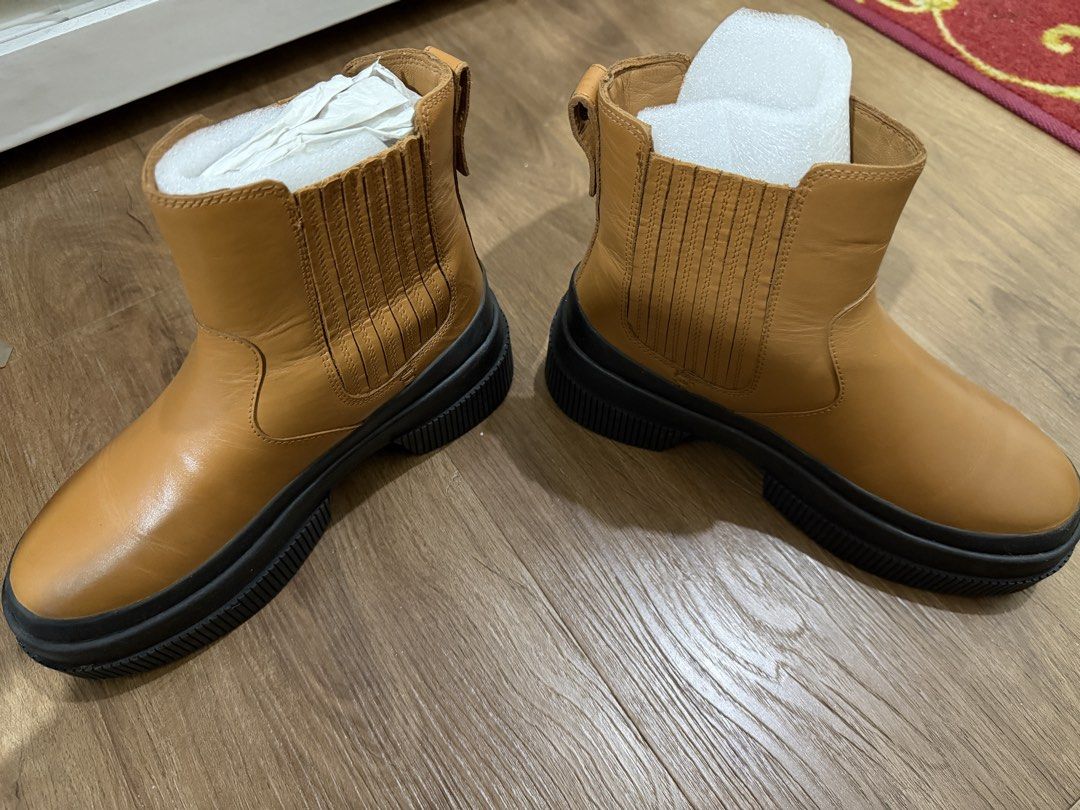 Tan Chelsea Boots Chunky Black Sole (Category: Boots) located in Pasig City. Submitted by swiftwhale.3e81de (Listing ID 1468914910, Image 2). Description: - Color: Tan - Style: Slip-on Chelsea boots with elastic side panels - Sole: Chunky black rubber lug sole - Features: Convenient heel pull tabs - Condition: Used once, still stuffed with protective paper inserts, no box - Size 5 - RFS: Bought new boots - Original bought at Official Sperry Store