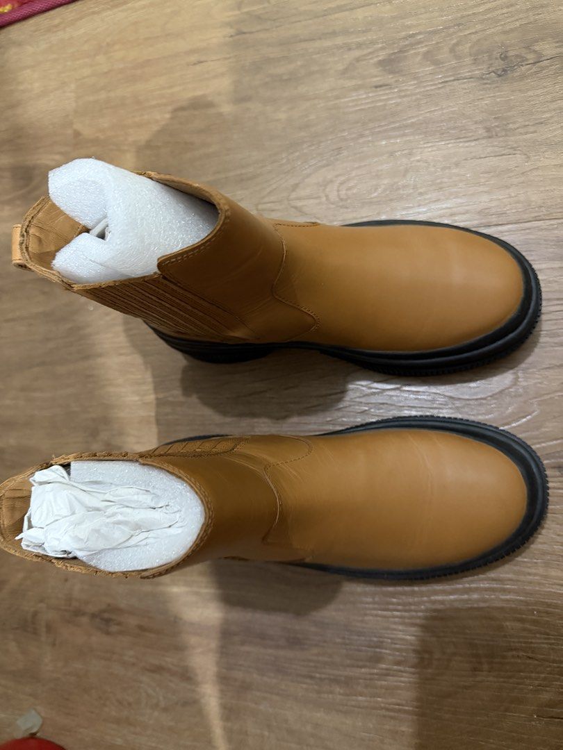Tan Chelsea Boots Chunky Black Sole (Category: Boots) located in Pasig City. Submitted by swiftwhale.3e81de (Listing ID 1468914910, Image 1). Description: - Color: Tan - Style: Slip-on Chelsea boots with elastic side panels - Sole: Chunky black rubber lug sole - Features: Convenient heel pull tabs - Condition: Used once, still stuffed with protective paper inserts, no box - Size 5 - RFS: Bought new boots - Original bought at Official Sperry Store