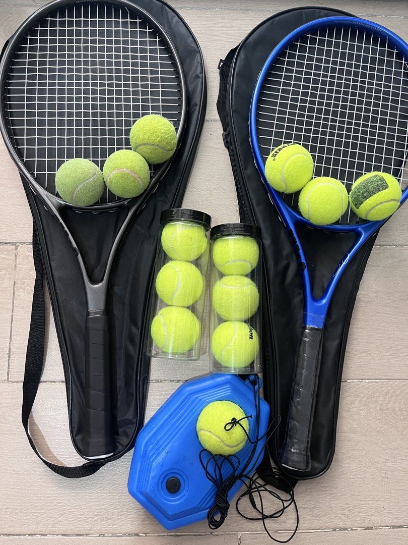 Tennis Set: 2 Rackets, Balls, Trainer (Category: Racket and Ball Sports) located in Taguig. Submitted by graceeeee. (Listing ID 1468732365, Image 1). Description: - Tennis Rackets (Black & Blue) with carrying cases - Tennis balls - Blue solo tennis trainer rebounder base with string and ball attachment for solo practice -Bought from Laz for 1,600+ Php -No issues. Lightly used; some balls used but mostly new RFS: moving out Loc: next to Venice Mal