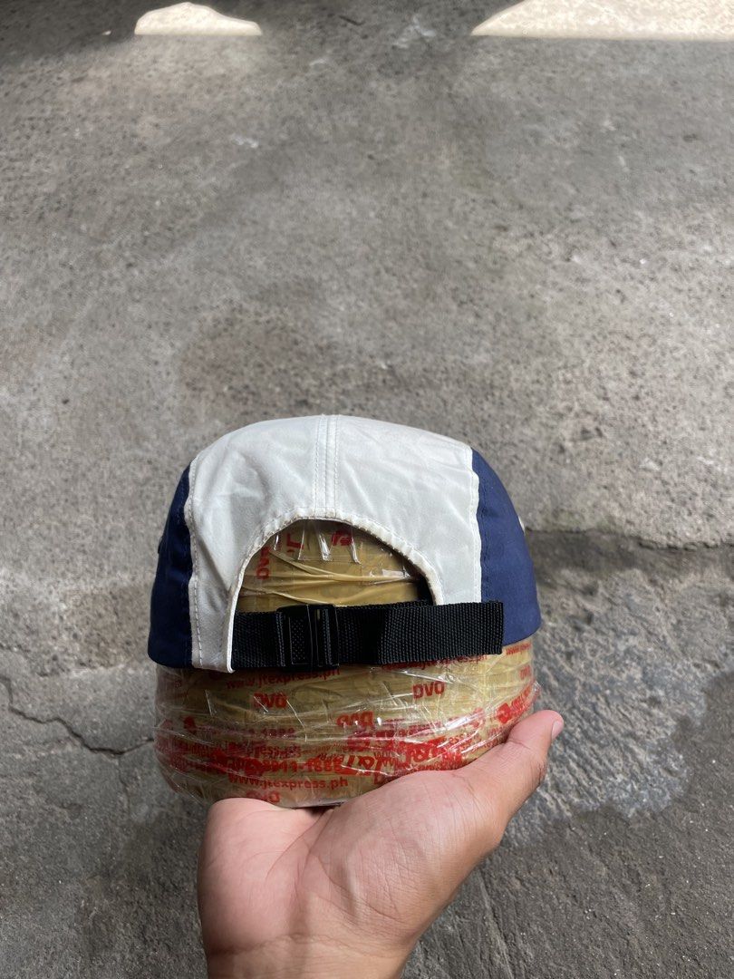 The Royal 'We' 5-Panel Cap (Category: Caps & Hats) located in General Santos City (Dadiangas). Submitted by christbluee (Listing ID 1468826479, Image 3). Description: - Brand: The Royal 'We' - Style: Colorblock 5-panel cap - Colors: White crown, red front panel, navy blue side panels and brim - Details: White branded patch on front, metal side eyelets for ventilation - Closure: Adjustable black strapback with plastic buckle - Condition: Excellent