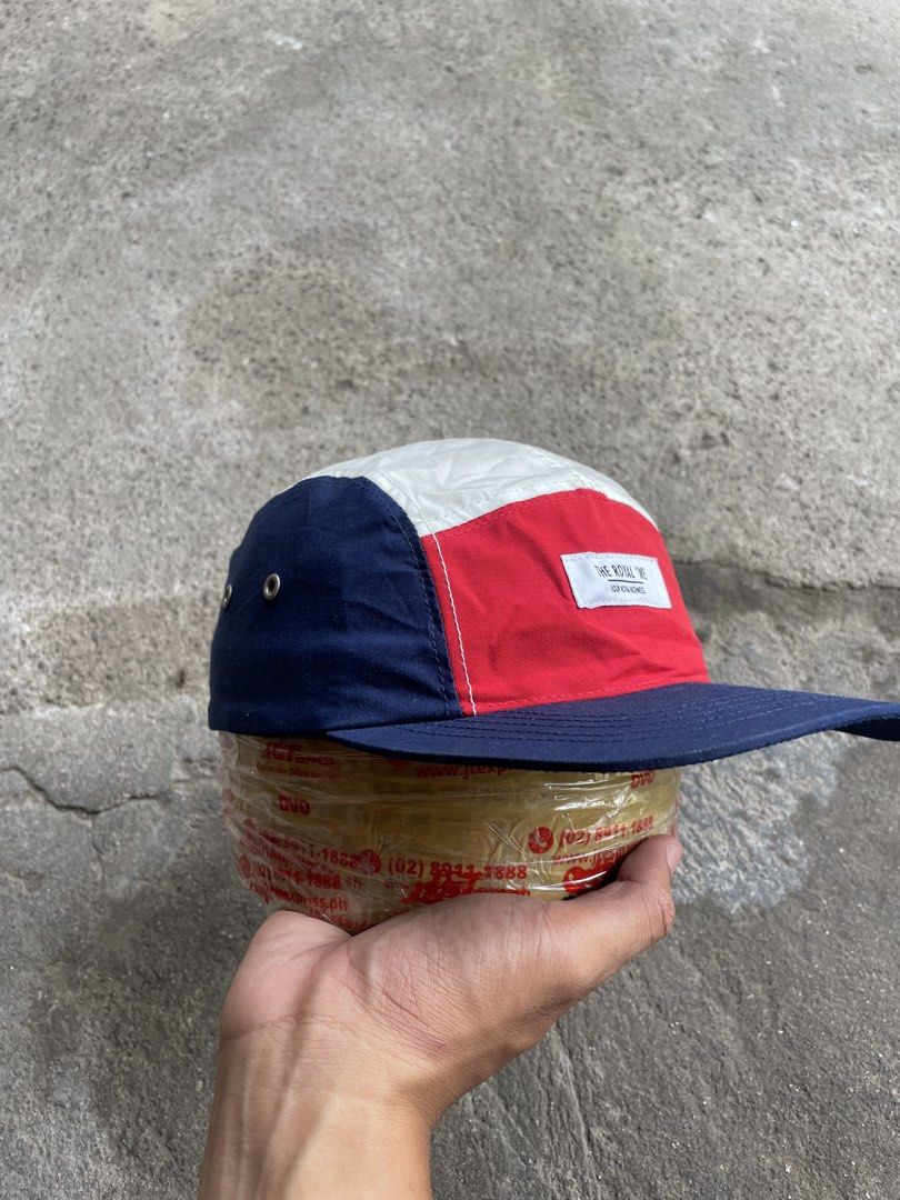 The Royal We Multi-Panel Camp Cap (Category: Caps & Hats) located in Polomolok. Submitted by madagascarts (Listing ID 1468796865, Image 2). Description: - Brand: The Royal We - Style: Colorblocked camp cap (Red front, white top, navy sides and brim) - Details: Front woven label patch and side eyelets - Closure: Adjustable nylon strap with plastic buckle - Condition: Clean interior with original brand tags intact.