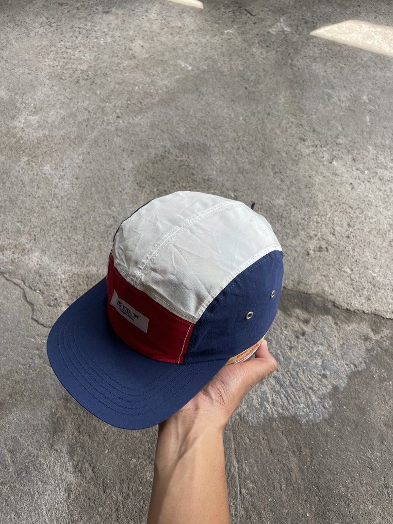 The Royal We Multi-Panel Camp Cap (Category: Caps & Hats) located in Polomolok. Submitted by madagascarts (Listing ID 1468796865, Image 3). Description: - Brand: The Royal We - Style: Colorblocked camp cap (Red front, white top, navy sides and brim) - Details: Front woven label patch and side eyelets - Closure: Adjustable nylon strap with plastic buckle - Condition: Clean interior with original brand tags intact.