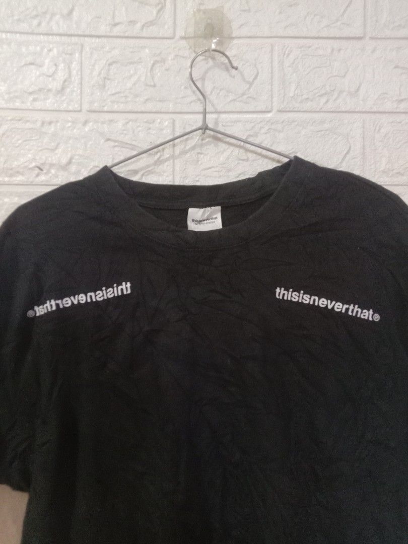 thisisneverthat (Category: Tshirts & Polo Shirts ) located in Quezon City. Submitted by coolture_thriftph (Listing ID 1468755169, Image 3). Description: - Brand: thisisneverthat - Color: Black - Size: Medium (collar tag) -Dimes 20w x 27L - Design: White branding on chest and back neckline, small logo tag near bottom hem - Fit: Classic crew neck, short sleeves - Material: Comfortable cotton - Condition: Clean overall shape, well-kept - Mode of Pay