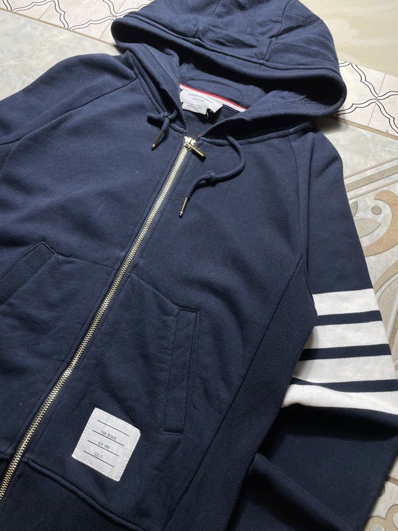 Thom Browne Classic Loopback 4-Bar Zip-Up Hoodie Navy Blue (Category: Coats, Jackets and Outerwear) located in Quezon City. Submitted by renovare.196 (Listing ID 1468887983, Image 2). Description: Thom Browne Classic Loopback 4-Bar Zip-Up Hoodie Navy Blue As New Condition Color Rate: 9.8/10 No Issue Measurements • Width: 19 • Length: 24.5 Price: 1500 obo DM IF INTERESTED📥.