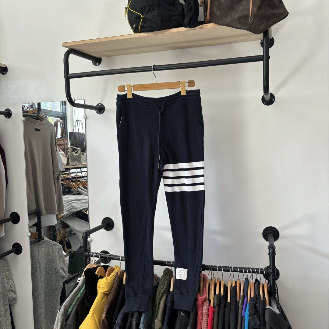 Thom Browne Navy 4-Bar Sweatpants Size 1 (Category: Joggers) located in Bambang. Submitted by heats777 (Listing ID 1468820887, Image 2). Description: - Brand: Thom Browne - Color: Navy - Signature white 4-bar stripes on the left leg - Adjustable drawstring waist with gold-tone aglets - Ribbed cuffs and woven size tag near the hem - Single back pocket with tricolor tab detail - Condition: 100% authentic and well-maintained - Mode of Payment: BPI /