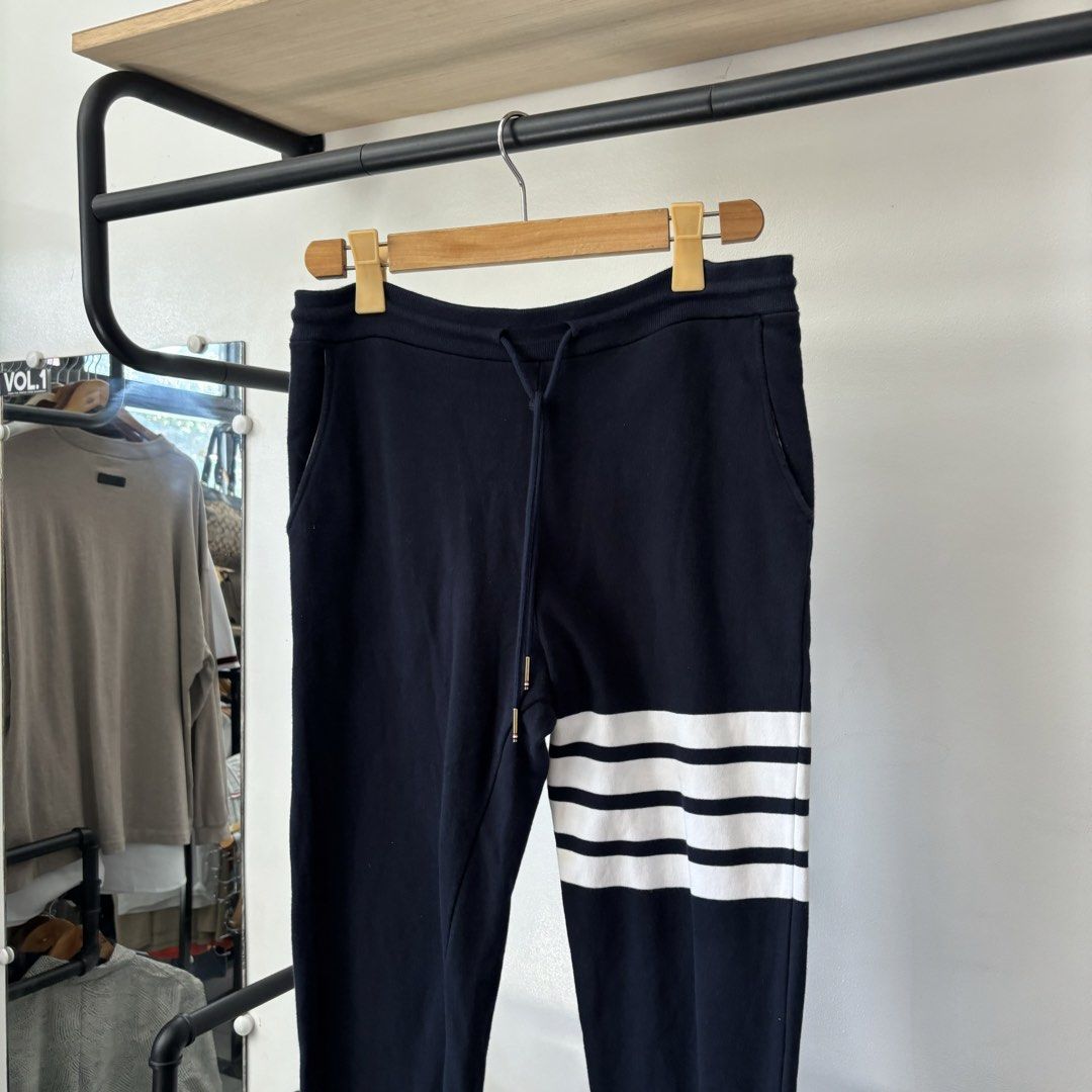Thom Browne Navy 4-Bar Sweatpants Size 1 (Category: Joggers) located in Bambang. Submitted by heats777 (Listing ID 1468820887, Image 1). Description: - Brand: Thom Browne - Color: Navy - Signature white 4-bar stripes on the left leg - Adjustable drawstring waist with gold-tone aglets - Ribbed cuffs and woven size tag near the hem - Single back pocket with tricolor tab detail - Condition: 100% authentic and well-maintained - Mode of Payment: BPI /