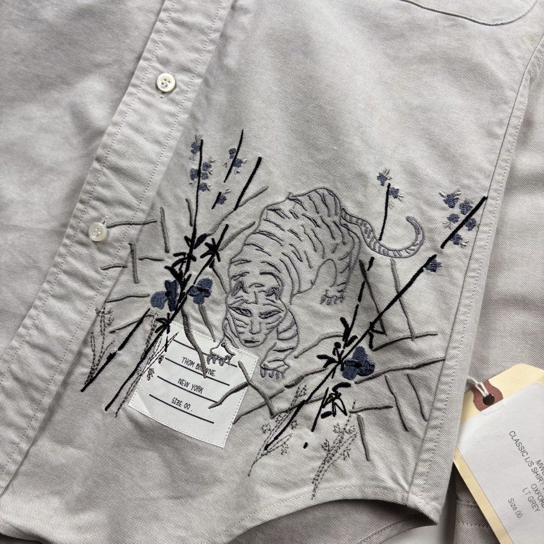 Thom Browne Tiger Embroidered Shirt (Category: Tshirts & Polo Shirts ) located in Makati City. Submitted by ragrepository (Listing ID 1468731248, Image 2). Description: Thom Browne Tiger Embroidered Shirt Tagged as 00 Length- 28” Pit to pit- 18” Sleeves- 24.5” Shoulder-15.5” Condition-NWT Flaw-Storage dust .