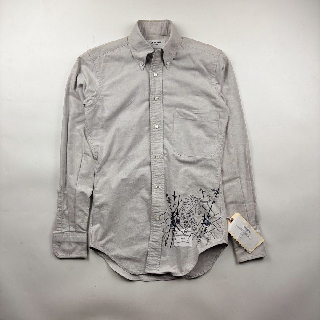 Thom Browne Tiger Embroidered Shirt (Category: Tshirts & Polo Shirts ) located in Makati City. Submitted by ragrepository (Listing ID 1468731248, Image 1). Description: Thom Browne Tiger Embroidered Shirt Tagged as 00 Length- 28” Pit to pit- 18” Sleeves- 24.5” Shoulder-15.5” Condition-NWT Flaw-Storage dust .