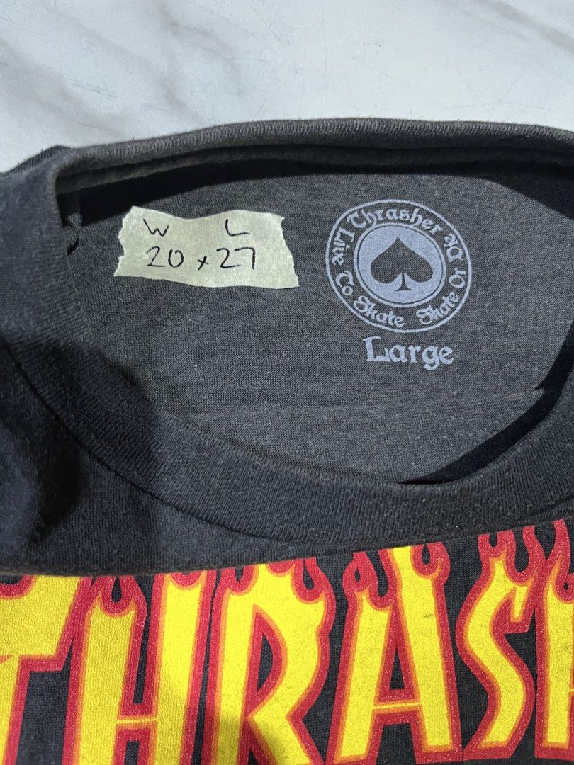 Thrasher Flame Logo Black T-Shirt (Category: Tshirts & Polo Shirts ) located in Cavite. Submitted by christianzuuu (Listing ID 1468780314, Image 2). Description: - Brand: Thrasher Magazine - Color: Black with classic flame logo graphic - Size: Large (Pit to pit: 20", Length: 27") - Style: Classic skate tee - Condition: Good pre-loved condition with a nice, clean fade on the collar from wash and wear.