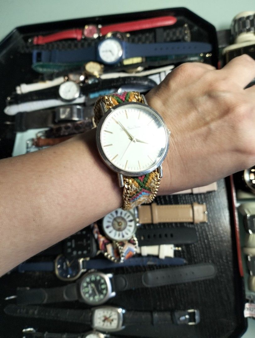 Three Four Time and Bohemian Quartz Watches Bundle (Category: Women's Watches) located in General Mariano Alvarez. Submitted by ma.miafajardo1219 (Listing ID 1468925224, Image 3). Description: - Set of 2 unique boho-style wristwatches - Features colorful woven fabric straps and stylish chain details - Watch 1: Clean white dial with 'Three Four Time' branding and minimalist stick markers - Watch 2: Detailed feather mandala design with reliable qua