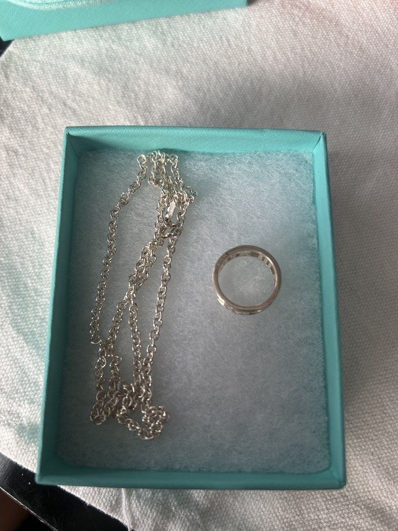 Tiffany & Co. Silver Ring and Chain Necklace (Category: Luxury Accessories) located in Cavite. Submitted by florabells (Listing ID 1468796202, Image 1). Description: - Brand: Auth. Tiffany & Co. - Material: Authentic sterling silver - Set Includes: atlas ring and link chain necklace - Packaging: Signature Tiffany blue gift box with original textured cotton padding - Condition: Excellent, classic silver polish -ring size: 54 - chain size : 18 inch