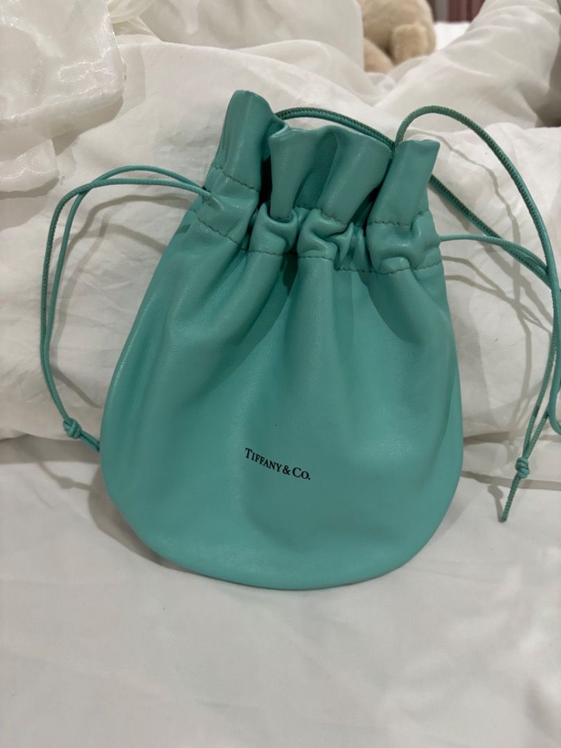 Tiffany & Co. Turquoise Leather Drawstring Bucket Bag (Category: Shoulder Bags) located in Makati City. Submitted by bravelion-b2bc (Listing ID 1468912199, Image 1). Description: - Brand: Tiffany & Co. - Material: lamb skin - Color: Signature Tiffany Blue - Style: Bucket bag (Crossbody or shoulder wear) - Closure: Drawstring - Interior: Matching leather lining with slip pockets - Origin: Made in Italy - Condition: Clean shape with minimal wear .