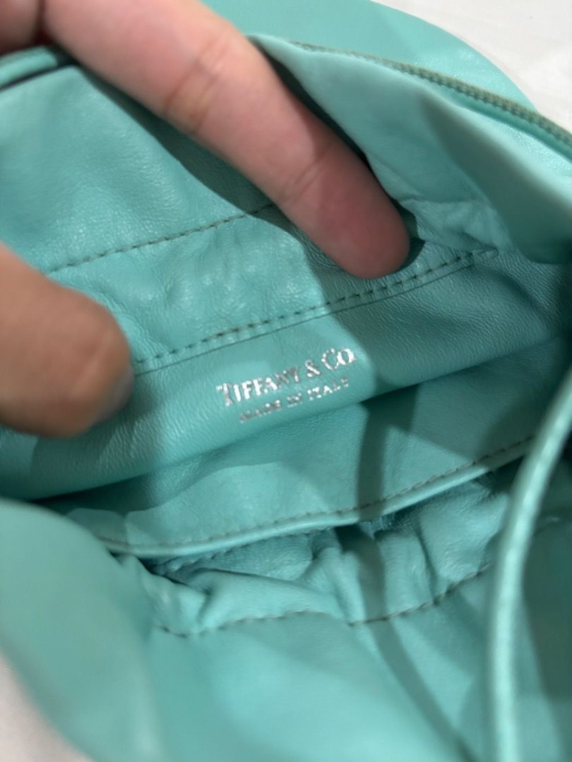 Tiffany & Co. Turquoise Leather Drawstring Bucket Bag (Category: Shoulder Bags) located in Makati City. Submitted by bravelion-b2bc (Listing ID 1468912199, Image 3). Description: - Brand: Tiffany & Co. - Material: lamb skin - Color: Signature Tiffany Blue - Style: Bucket bag (Crossbody or shoulder wear) - Closure: Drawstring - Interior: Matching leather lining with slip pockets - Origin: Made in Italy - Condition: Clean shape with minimal wear .