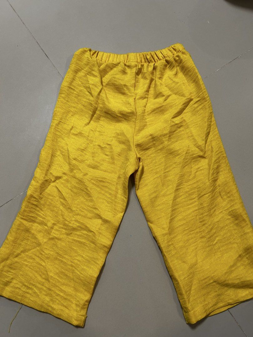 Toddler Yellow Ruffle Top and Pants Set (Category: Babies & Kids Fashion) located in Antipolo. Submitted by mommytj (Listing ID 1468742651, Image 3). Description: - Item: Girls bright yellow two-piece set - Top: Sleeveless with ruffled hem and decorative side bows - Bottoms: Pull-up pants with a comfortable elastic waistband - Fabric: Lightweight and breathable, perfect for warm weather - Condition: Worn once for photos, freshly washed and cleane