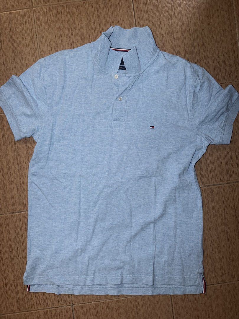 Tommy Hilfiger for 2 (Category: Tshirts & Polo Shirts ) located in Taguig. Submitted by zelpremo (Listing ID 1468756919, Image 1). Description: - Brand: Tommy Hilfiger - Gray may lints - Material: 100% breathable cotton - Color: Light blue - Design: Classic collar with two-button placket - Detail: Iconic small embroidered flag logo on the chest - Versatility: Easy to style with casual jeans or shorts - Condition: Clean look, ready to wear.