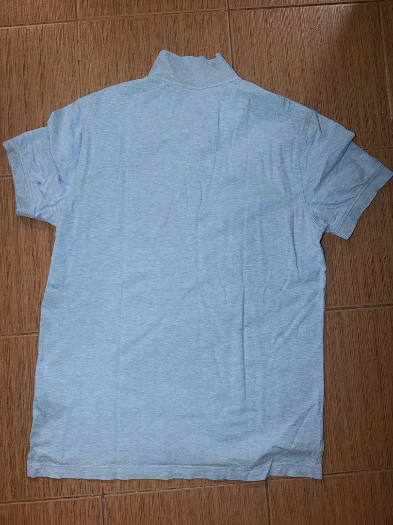 Tommy Hilfiger for 2 (Category: Tshirts & Polo Shirts ) located in Taguig. Submitted by zelpremo (Listing ID 1468756919, Image 2). Description: - Brand: Tommy Hilfiger - Gray may lints - Material: 100% breathable cotton - Color: Light blue - Design: Classic collar with two-button placket - Detail: Iconic small embroidered flag logo on the chest - Versatility: Easy to style with casual jeans or shorts - Condition: Clean look, ready to wear.