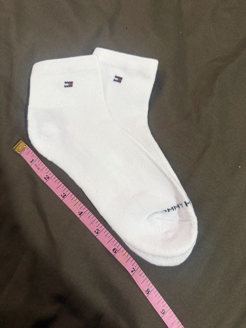 Tommy Hilfiger White Ankle Socks (Category: Socks & Tights) located in Quezon City. Submitted by turtleandfishes (Listing ID 1468737232, Image 3). Description: - Brand: Tommy Hilfiger - Style: Ankle socks - Color: Clean white - Features: Small logo embroidery near cuff, ribbed texture for stretch and comfort, and Tommy lettering printed across the toe.