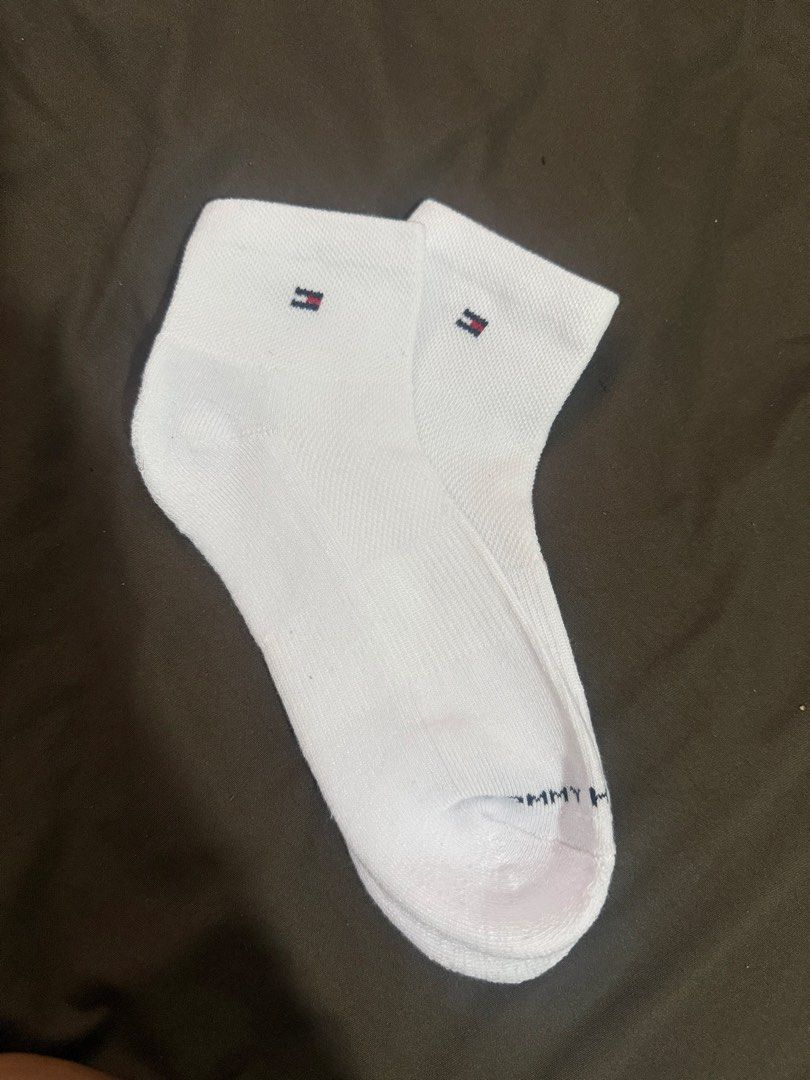 Tommy Hilfiger White Ankle Socks (Category: Socks & Tights) located in Quezon City. Submitted by turtleandfishes (Listing ID 1468737232, Image 2). Description: - Brand: Tommy Hilfiger - Style: Ankle socks - Color: Clean white - Features: Small logo embroidery near cuff, ribbed texture for stretch and comfort, and Tommy lettering printed across the toe.