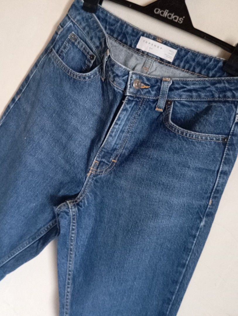 Topshop Blue Denim Jeans (Category: Jeans) located in Cabanatuan. Submitted by w3ng.gay (Listing ID 1468751349, Image 2). Description: - Brand: Topshop - Style: High waist, straight leg - Wash: Medium blue with contrast stitching - Details: 5-pocket setup, button and zip fly closure - Condition: Excellent everyday wardrobe staple, easy to style.