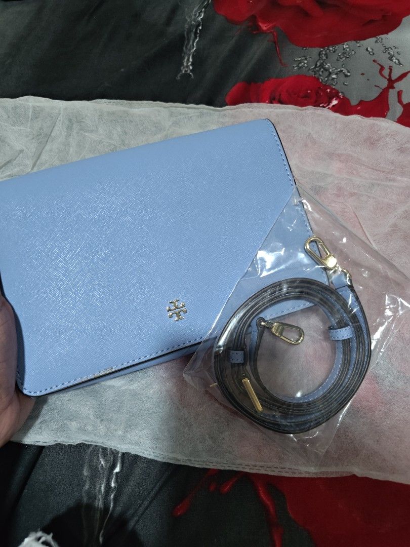 Tory Burch Blue Crossbody Bag with Strap (Category: Cross-body Bags) located in Valenzuela. Submitted by wisewhale_46982b (Listing ID 1468779363, Image 3). Description: - Brand: Tory Burch Crossbody Bag - Color: Light Blue with Gold-tone Hardware - Material: Durable Saffiano Leather - Inclusions: Detachable shoulder strap (brand new in plastic wrapper) - Condition: Clean interior, structured shape, with a minor wear mark on the side edge near the