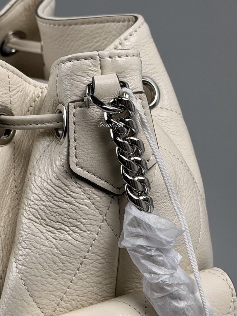 Tory Burch Charlie Quilted Drawstring Shoulder Bag Light Cream (Category: Shoulder Bags) located in Angeles City. Submitted by gobagsto (Listing ID 1468738805, Image 3). Description: - Brand: Tory Burch Charlie - Style: Quilted drawstring shoulder bag - Color: Light cream with silver-tone hardware - Features: Iconic logo toggle, dual side pockets with flap closures, and chain strap detail - Condition: Brand new with original tags attached and pro