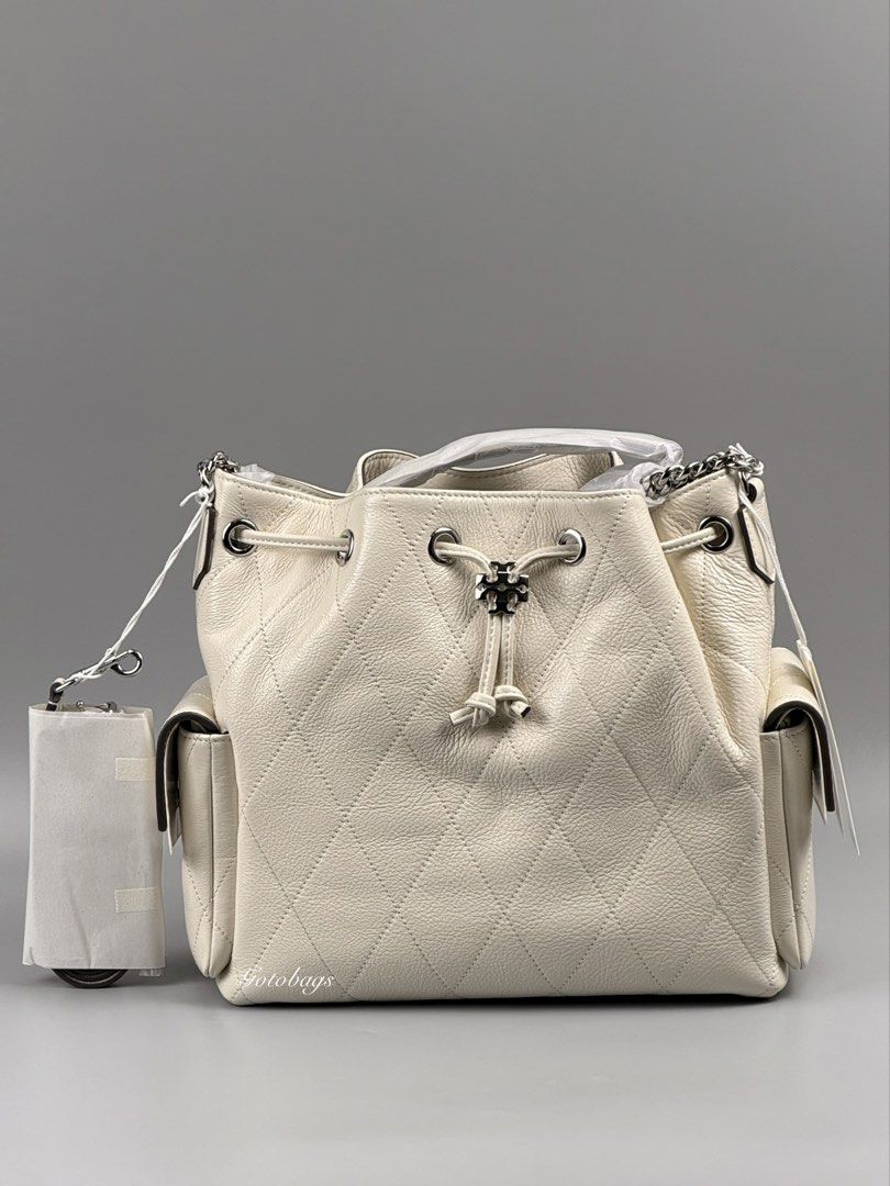 Tory Burch Charlie Quilted Drawstring Shoulder Bag Light Cream (Category: Shoulder Bags) located in Angeles City. Submitted by gobagsto (Listing ID 1468738805, Image 2). Description: - Brand: Tory Burch Charlie - Style: Quilted drawstring shoulder bag - Color: Light cream with silver-tone hardware - Features: Iconic logo toggle, dual side pockets with flap closures, and chain strap detail - Condition: Brand new with original tags attached and pro