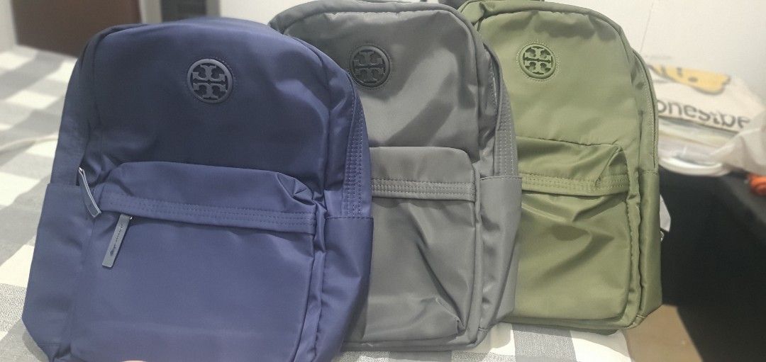 Tory Burch Nylon Backpack Multiple Colors Available (Category: Backpacks) located in Paranaque City. Submitted by personal_preloved40 (Listing ID 1468924740, Image 1). Description: - 100% Brand new with tags and original packaging plastic - Stylish colorblock design in navy, grey, and olive green - Lightweight nylon material perfect for daily use - Spacious main compartment for your everyday essentials - Front zippered pocket featuring the signat