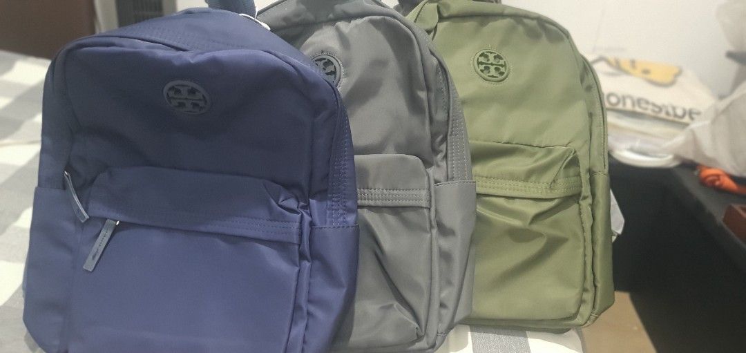 Tory Burch Nylon Backpack Multiple Colors Available (Category: Backpacks) located in Paranaque City. Submitted by personal_preloved40 (Listing ID 1468924740, Image 2). Description: - 100% Brand new with tags and original packaging plastic - Stylish colorblock design in navy, grey, and olive green - Lightweight nylon material perfect for daily use - Spacious main compartment for your everyday essentials - Front zippered pocket featuring the signat