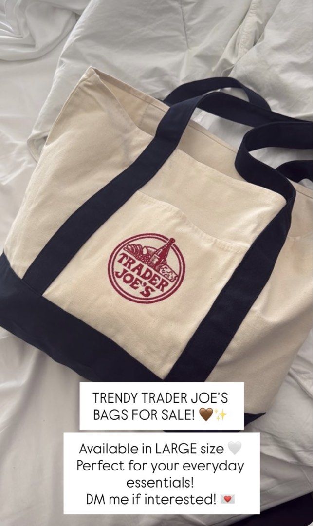 Trader Joe's Reusable Canvas Tote Bag Large (Category: Tote Bags) located in Manila. Submitted by richelann34088 (Listing ID 1468764299, Image 1). Description: - 100% Authentic Trader Joe's canvas tote bag - Large size with a spacious interior for all your everyday essentials - Stylish cream body paired with contrasting dark navy blue straps and bottom panel - Features a striking red embroidered Trader Joe's logo on the front pocket.