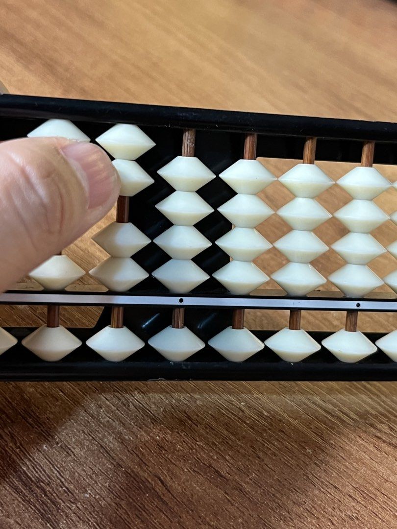 Traditional Soroban Abacus 13-Rod Calculating Tool (Category: Stationery & School Supplies) located in Gapan. Submitted by lunashop14 (Listing ID 1468715260, Image 2). Description: - Type: Standard 13-rod Japanese soroban abacus - Design: Solid black frame with smooth-sliding cream beads on copper rods - Features: Clear counter markings along the horizontal beam - Condition: Clean with minimal signs of handling - Ideal for: Math practice, mental 