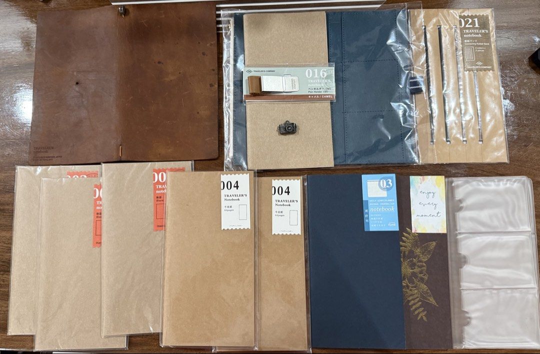 Traveler’s Notebook Set (Category: Other Stationery & Craft) located in Manila. Submitted by tater_thoughts (Listing ID 1468775715, Image 1). Description: Sold as Set TN Camel Standard Size Camel Pen Holder 007 Card File (Used) (2)004 Blank Refills 03 Daily Planner Blue Pouch Insert 021 Connecting Rubber Band Grid Insert with Gold Foil Design Original Refill Camera Charm Note: Marks were from mold but the cover was cleaned and dried thoroughly. M