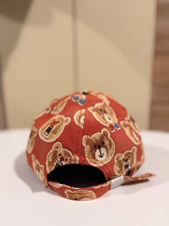 TTWN Bear Orange Teddy Bear Print Baseball Cap (Category: Vintage Collectibles) located in Cebu City. Submitted by ubecstoned (Listing ID 1468819215, Image 3). Description: - Brand: TTWN Bear - Color: Vibrant orange with all-over woven teddy bear pattern (includes bears in blue bowties) - Material: 100% cotton with black inner lining and branded tag - Fit: Adjustable metal strap closure at the back.