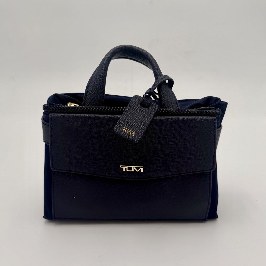 TUMI Navy Blue Convertible Backpack Tote (Category: Backpacks) located in Manila. Submitted by mrjalandoni (Listing ID 1468762240, Image 2). Description: - Authentic Navy Blue TUMI Convertible Bag - Wear as a backpack or carry by top handles - Elegant Saffiano leather trim on front flap pocket and top handle - Premium gold-tone hardware with matching TUMI luggage tag - Secure zip top closure - Clean dark interior lining.