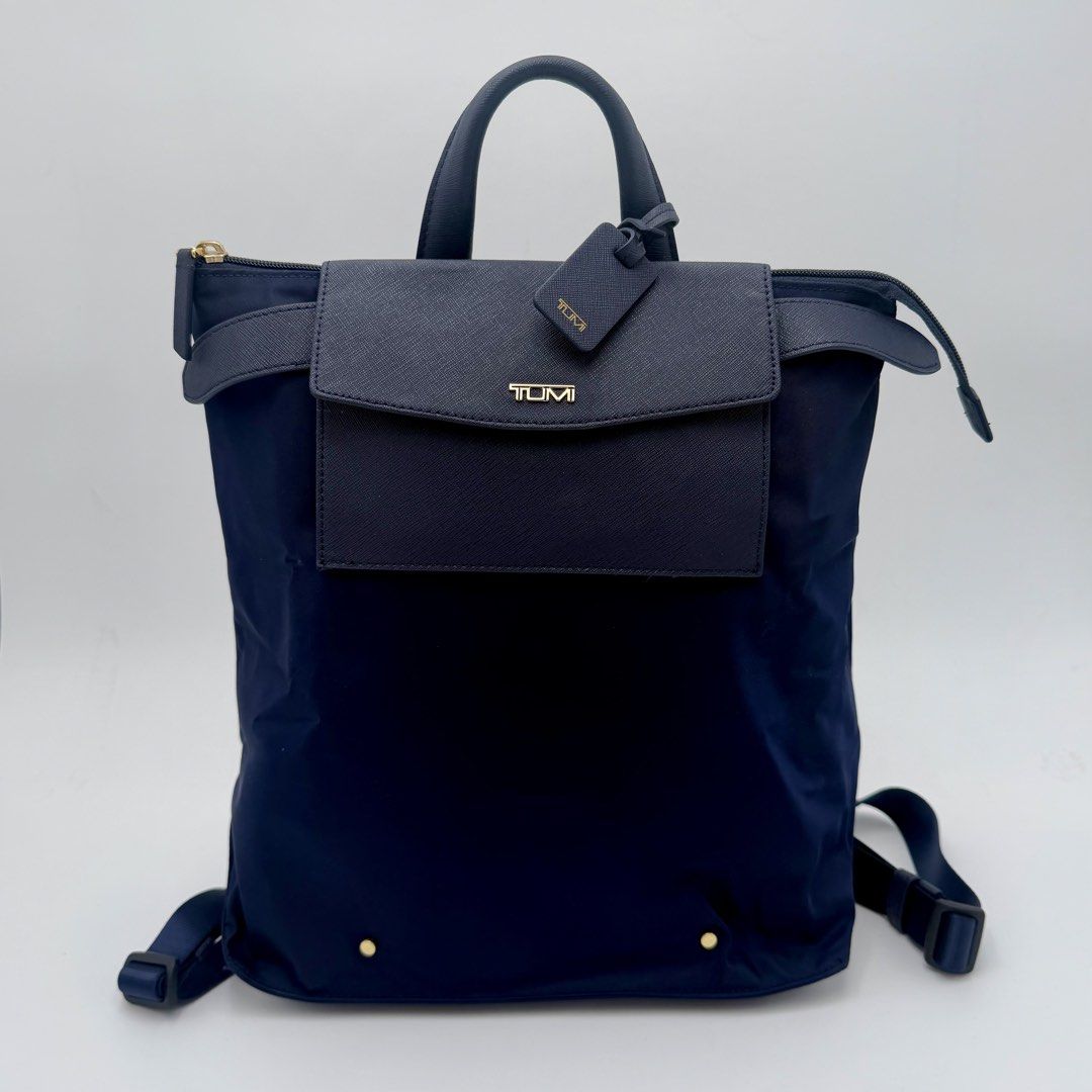 TUMI Navy Blue Convertible Backpack Tote (Category: Backpacks) located in Manila. Submitted by mrjalandoni (Listing ID 1468762240, Image 1). Description: - Authentic Navy Blue TUMI Convertible Bag - Wear as a backpack or carry by top handles - Elegant Saffiano leather trim on front flap pocket and top handle - Premium gold-tone hardware with matching TUMI luggage tag - Secure zip top closure - Clean dark interior lining.