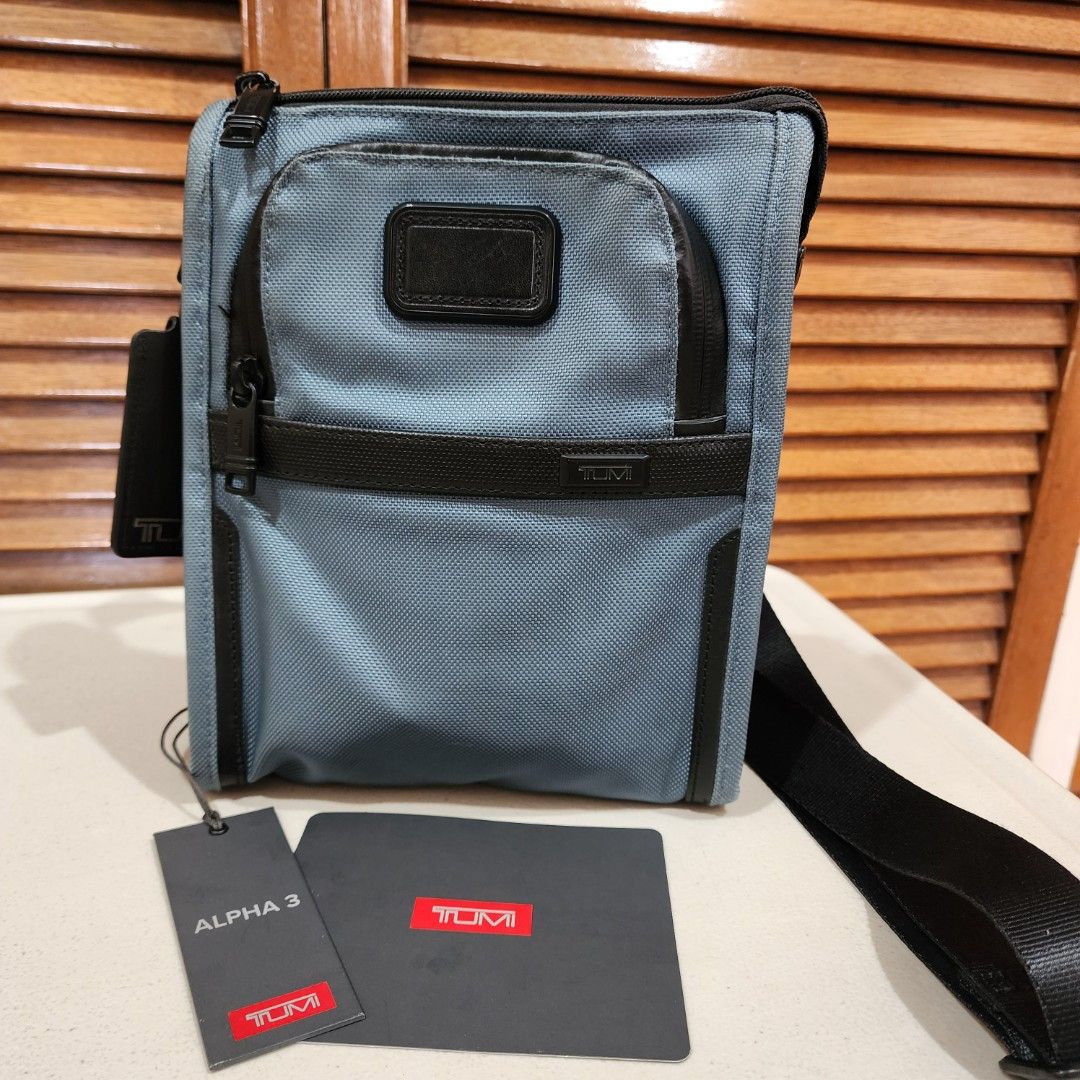 TUMI sling bag mens (Category: Sling Bags) located in Manila. Submitted by windelynon66264 (Listing ID 1468723657, Image 2). Description: TUMI Alpha 3 Pocket Bag Small in blue. Made from FXT ballistic nylon with leather accents and polyester lining. Measures 9.5" x 8" x 1.5". Adjustable shoulder strap, multiple zip compartments, and TUMI Tracer plate inside. Original tags attached, retail price $225.00. just need slight cleaning. monogram patch s