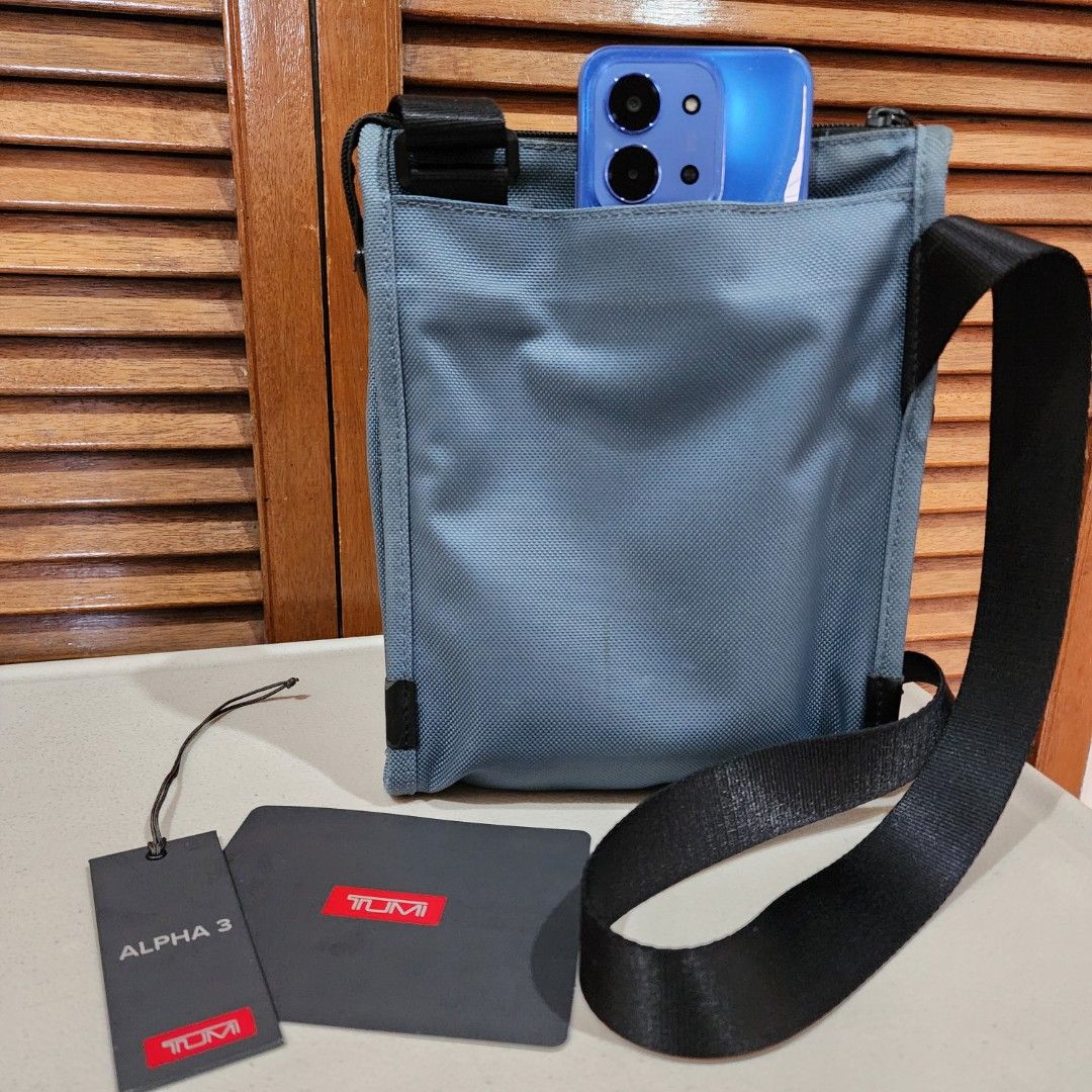 TUMI sling bag mens (Category: Sling Bags) located in Manila. Submitted by windelynon66264 (Listing ID 1468723657, Image 3). Description: TUMI Alpha 3 Pocket Bag Small in blue. Made from FXT ballistic nylon with leather accents and polyester lining. Measures 9.5" x 8" x 1.5". Adjustable shoulder strap, multiple zip compartments, and TUMI Tracer plate inside. Original tags attached, retail price $225.00. just need slight cleaning. monogram patch s