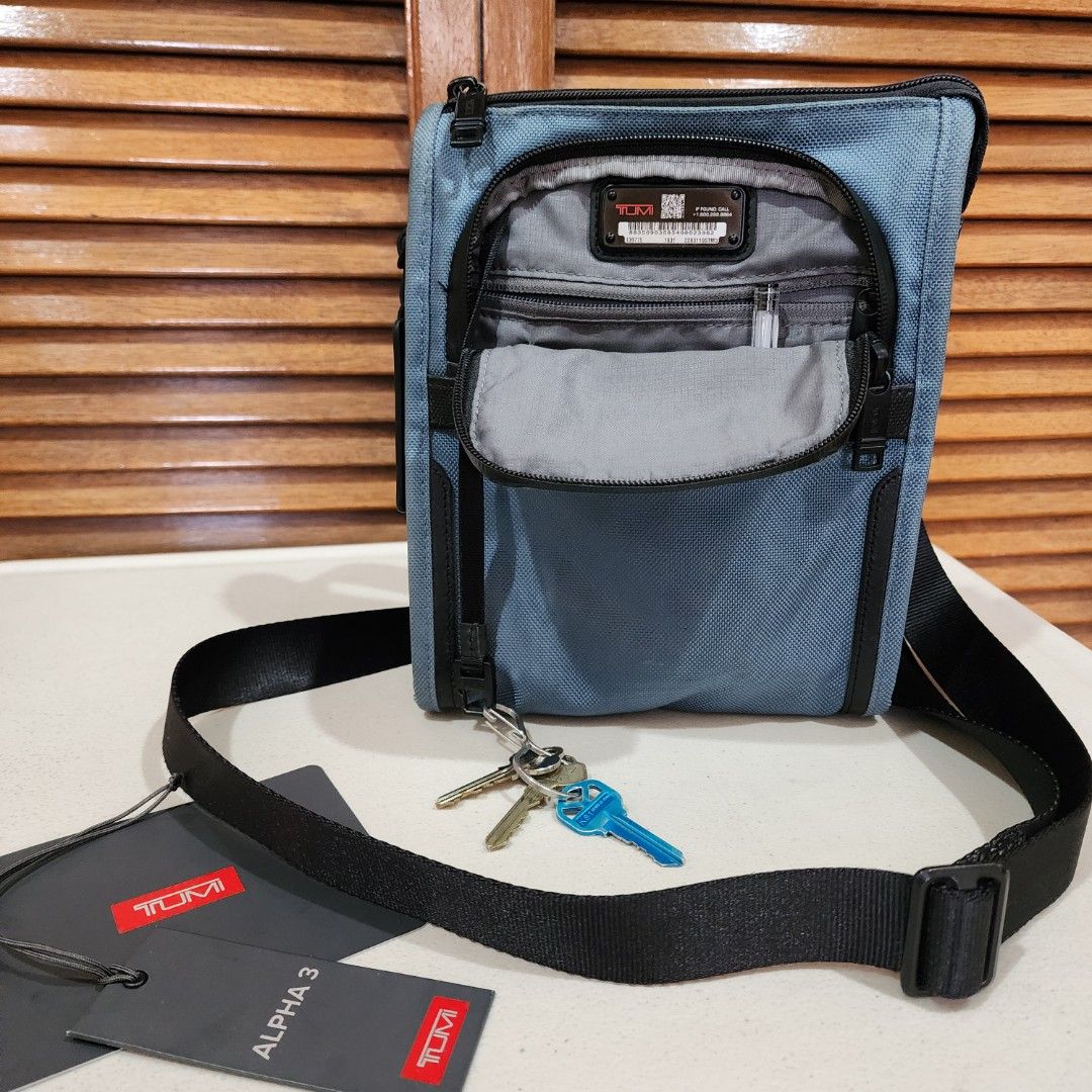 TUMI sling bag mens (Category: Sling Bags) located in Manila. Submitted by windelynon66264 (Listing ID 1468723657, Image 1). Description: TUMI Alpha 3 Pocket Bag Small in blue. Made from FXT ballistic nylon with leather accents and polyester lining. Measures 9.5" x 8" x 1.5". Adjustable shoulder strap, multiple zip compartments, and TUMI Tracer plate inside. Original tags attached, retail price $225.00. just need slight cleaning. monogram patch s