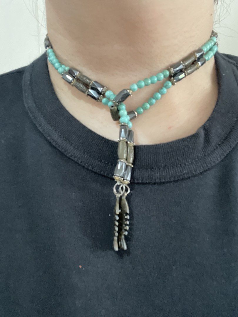 Turquoise Beaded Necklace with Fish Bone Charms (Category: Necklaces) located in San Juan City. Submitted by redrosierose (Listing ID 1468713544, Image 2). Description: - Dual-strand design: Can be worn as a choker or layered look - Materials: Turquoise round beads, metallic faceted beads, and grey cylinder beads - Distinctive details: Finished with playful dangling fish skeleton charms - Style: Boho aesthetic with earthy tones - Perfect for addi