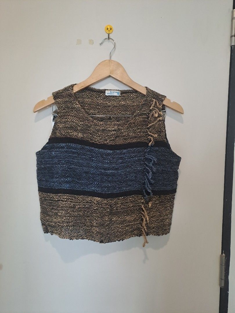 Tweed sleeveless (Category: Sleeveless) located in Manila. Submitted by joanbalde39643 (Listing ID 1468754337, Image 3). Description: This garment is a vintage multi-toned woven sleeveless top with a fringed wrap detail. It features a chunky, textured marled weave in earthy brown, black, and blue horizontal stripes. The prominent crossover overlay panel fastens diagonally across the bodice, highlighted by a decorative fringed border or tassel tri