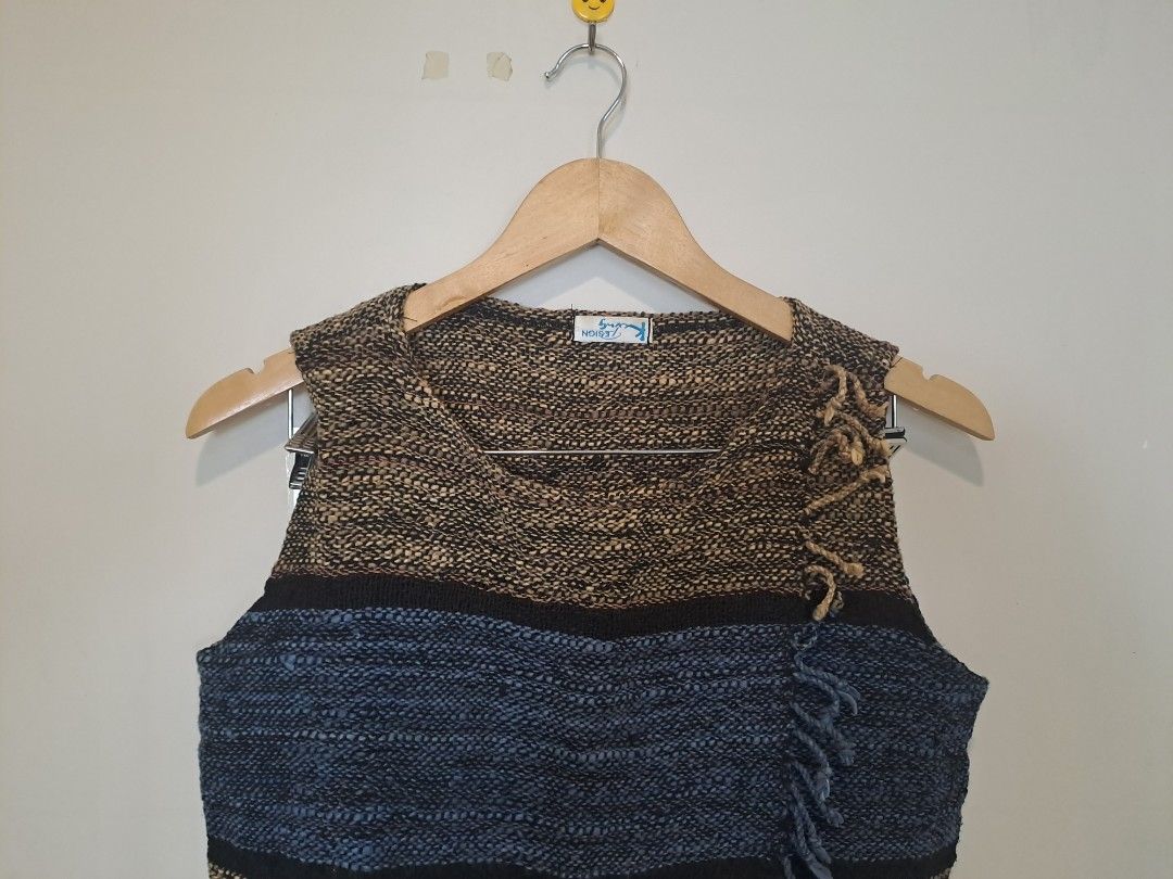 Tweed sleeveless (Category: Sleeveless) located in Manila. Submitted by joanbalde39643 (Listing ID 1468754337, Image 1). Description: This garment is a vintage multi-toned woven sleeveless top with a fringed wrap detail. It features a chunky, textured marled weave in earthy brown, black, and blue horizontal stripes. The prominent crossover overlay panel fastens diagonally across the bodice, highlighted by a decorative fringed border or tassel tri