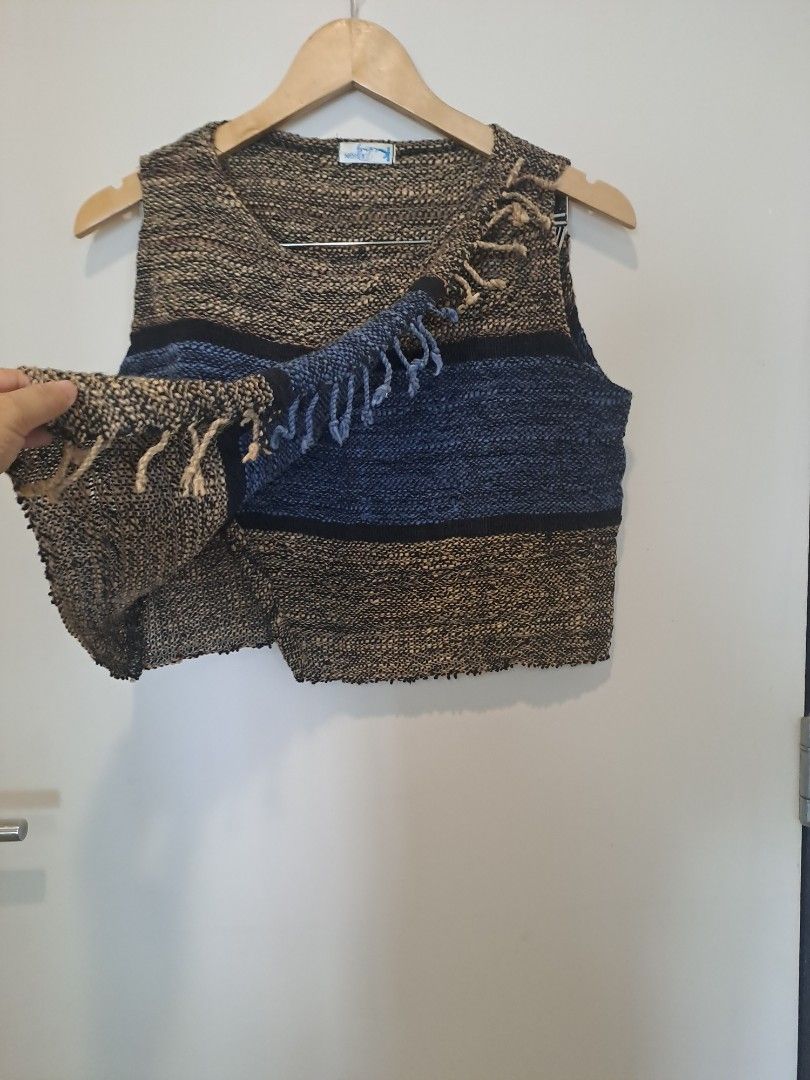 Tweed sleeveless (Category: Sleeveless) located in Manila. Submitted by joanbalde39643 (Listing ID 1468754337, Image 2). Description: This garment is a vintage multi-toned woven sleeveless top with a fringed wrap detail. It features a chunky, textured marled weave in earthy brown, black, and blue horizontal stripes. The prominent crossover overlay panel fastens diagonally across the bodice, highlighted by a decorative fringed border or tassel tri