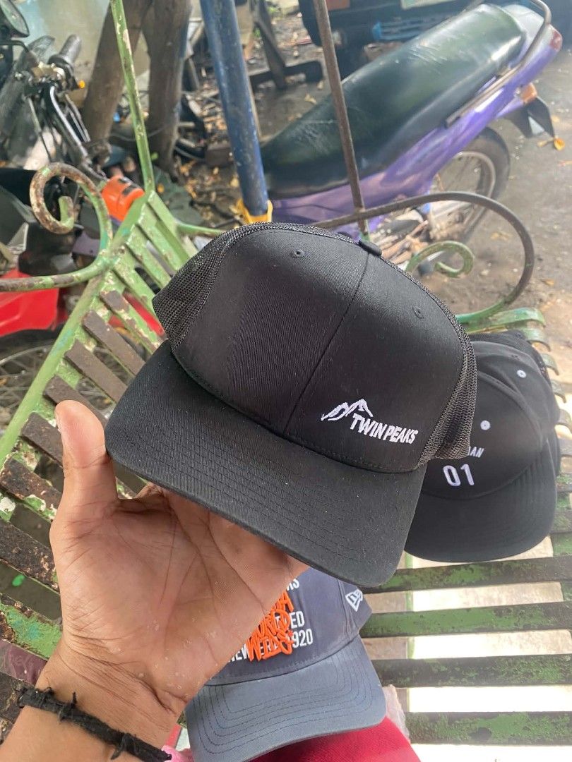 Twin Peaks Black Trucker Hat Snapback (Category: Caps & Hats) located in Sibulan. Submitted by thethiftedcap0728 (Listing ID 1468735037, Image 1). Description: - Color: Black - Design: Embroidered Twin Peaks logo on front - Material: Breathable mesh back panels - Fit: Adjustable plastic snapback closure - Brim: Classic curved style - Authenticity: Original Yupoong 'The Classics' branding tag inside.