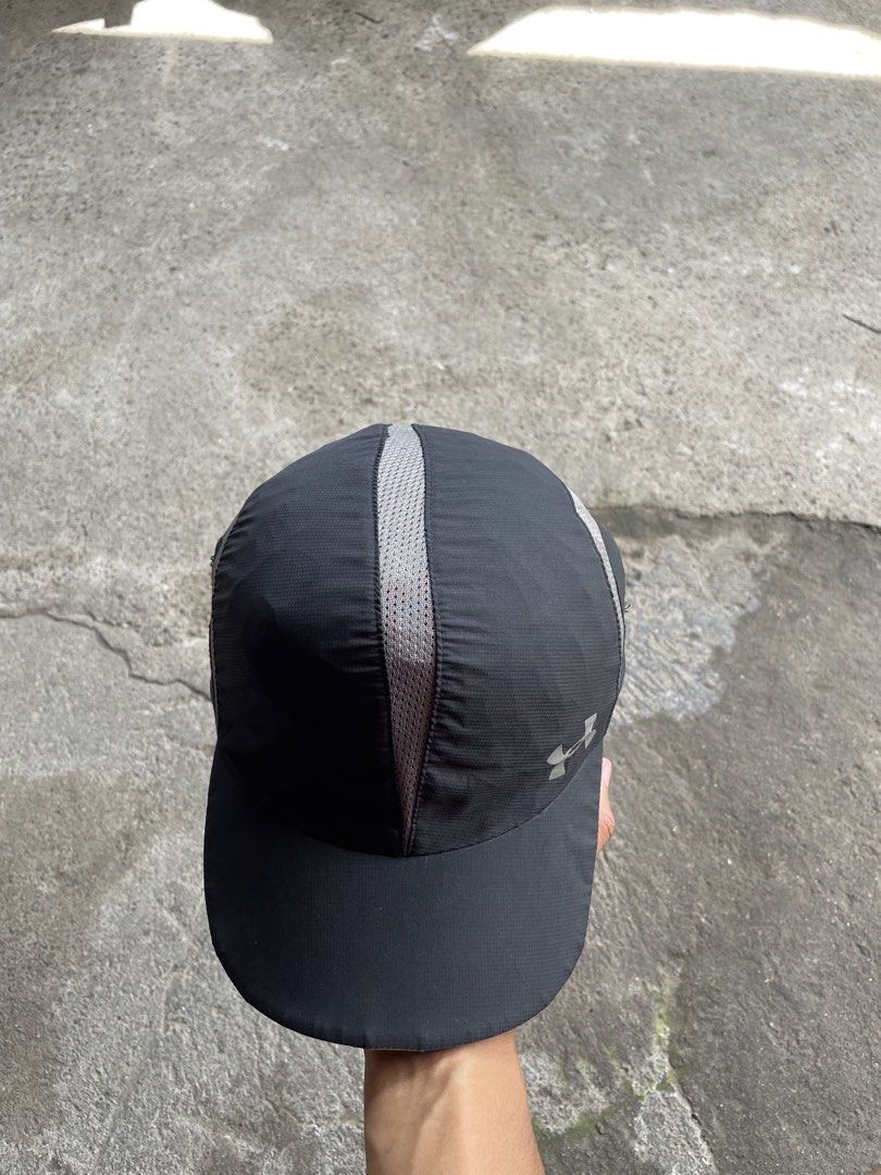 Under Armour Running Cap Black Gray (Category: Caps & Hats) located in Polomolok. Submitted by madagascarts (Listing ID 1468797049, Image 3). Description: - Brand: Under Armour - Color: Black and gray with blue accent piping on the brim - Breathable: Mesh panels on center and sides for maximum airflow - Storage: Convenient small zippered pocket on the left side panel - Visibility: Reflective logo detail on the front for low-light safety - Fit: Fu