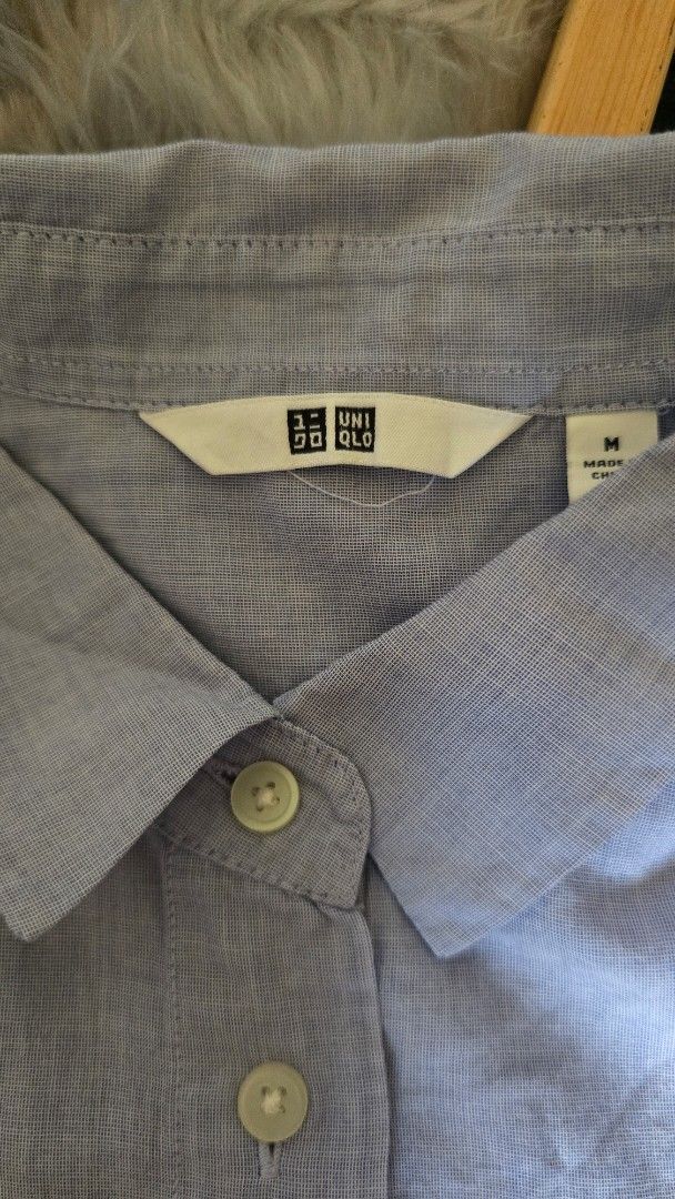 Uniqlo Light Blue Button-Up Shirt Medium (Category: Tshirts & Polo Shirts ) located in Cabanatuan. Submitted by belle_1013 (Listing ID 1468762986, Image 2). Description: - Brand: Uniqlo - Color: Light Blue - Size: Medium (tag on collar) - Style: Classic collared neckline with front button closure - Material: Lightweight fabric - Condition: Good overall condition, perfect for casual wear or layering.