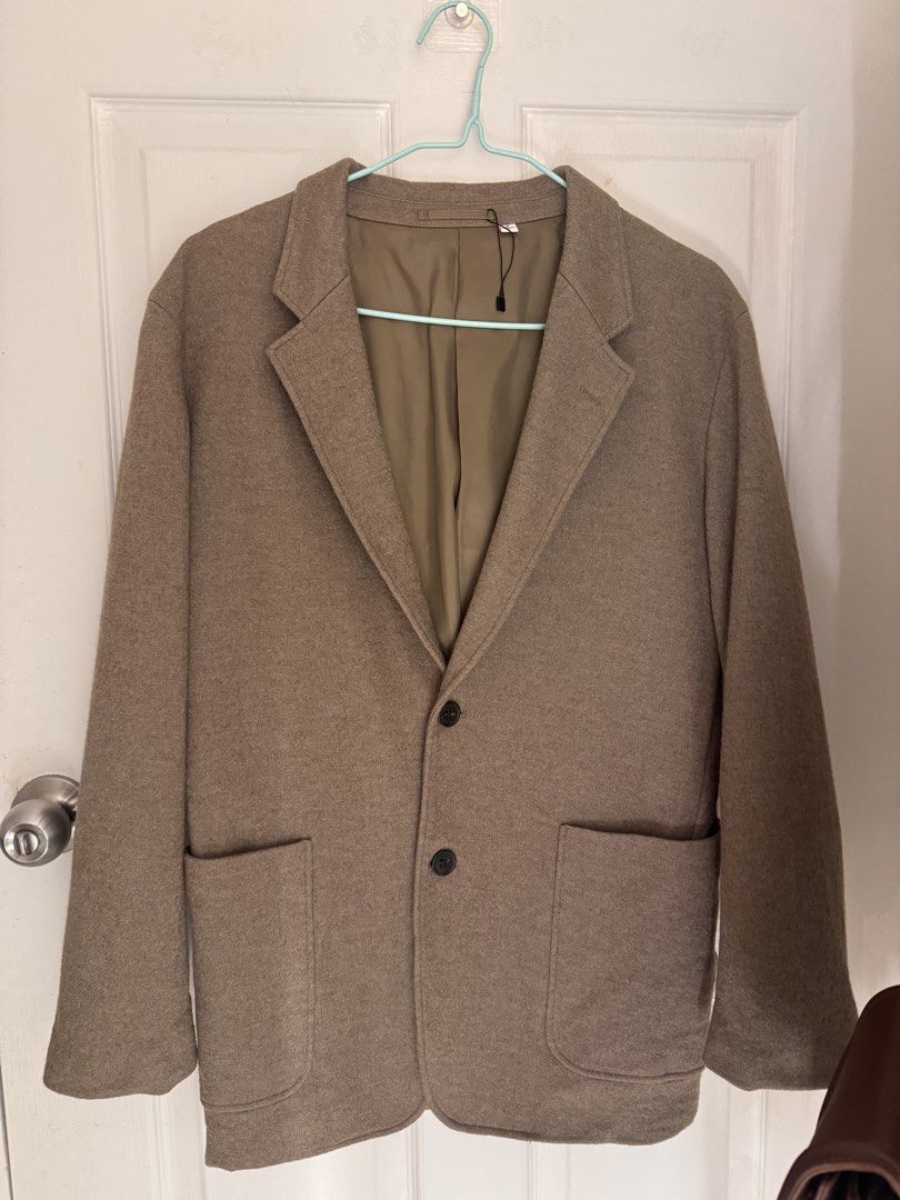 Uniqlo U Wool Blend Tailored Jacket Brown Medium (Category: Coats, Jackets and Outerwear) located in Cabanatuan. Submitted by omojiee (Listing ID 1468714052, Image 1). Description: - Brand: Uniqlo U - Style: Brown blazer - Size: M - Material: Wool blend with smooth inner lining - Features: Two front buttons, patch pockets, and an inside pocket - Condition: Clean, brand new with tag still attached on the collar.