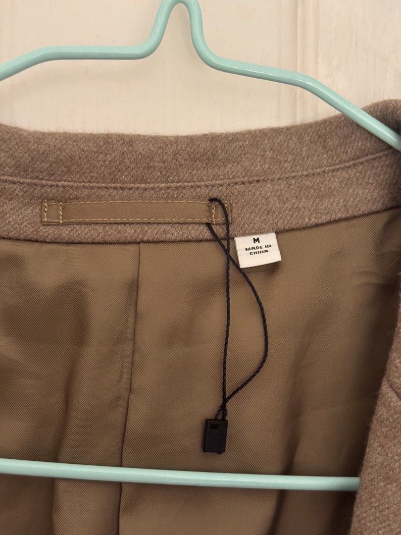 Uniqlo U Wool Blend Tailored Jacket Brown Medium (Category: Coats, Jackets and Outerwear) located in Cabanatuan. Submitted by omojiee (Listing ID 1468714052, Image 2). Description: - Brand: Uniqlo U - Style: Brown blazer - Size: M - Material: Wool blend with smooth inner lining - Features: Two front buttons, patch pockets, and an inside pocket - Condition: Clean, brand new with tag still attached on the collar.