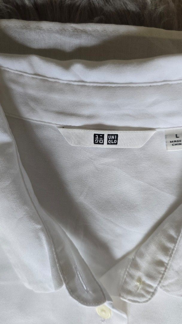 Uniqlo White Button Down Shirt Size L (Category: Shirts) located in Cabanatuan. Submitted by belle_1013 (Listing ID 1468762408, Image 2). Description: - Brand: Uniqlo - Color: Clean White - Style: Short sleeves, classic collar, button-down - Size: L (Tag on collar) - Fabric: Lightweight and breathable - Versatility: Easy to style for work or casual outfits - Condition: Excellent.