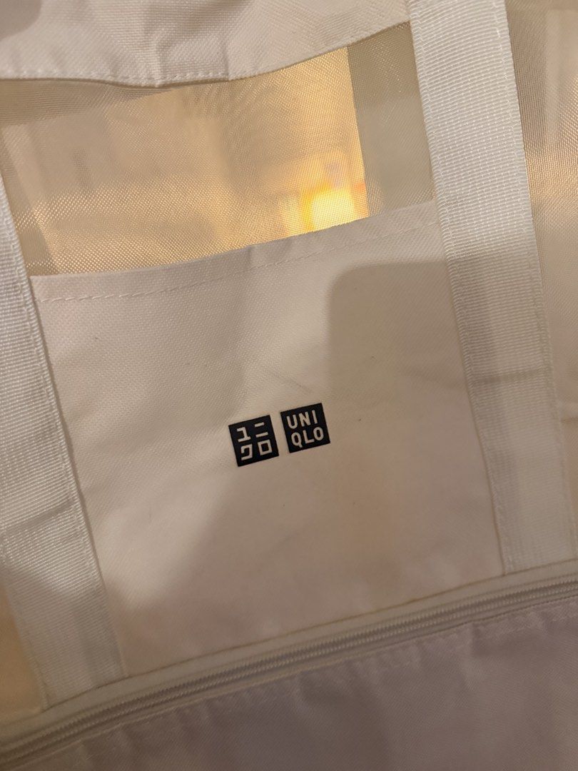 Uniqlo White Mesh Tote Bag With Bottom Compartment (Category: Tote Bags) located in Mandaluyong City. Submitted by ohayouclub (Listing ID 1468854968, Image 3). Description: - Brand: Uniqlo - Color: White - Material: Lightweight and durable mesh - Features: Sturdy top handles for easy carrying - Pocket: Front pocket with Uniqlo logo patch - Compartment: Handy zip compartment at the bottom - Condition: Clean overall.